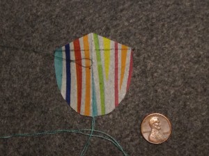 2 inch Sotich Shield kite, striped cocktail napkin.